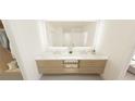 Elegant bathroom features a double vanity, marble countertop, and soft lighting to create a luxurious spa-like experience at 4950 Remington Dr # 104, Sarasota, FL 34234