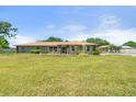 Charming single-story home featuring a well-manicured lawn and blue shutters at 5024 37Th E St, Bradenton, FL 34203