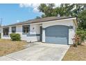 Home featuring attached garage, concrete driveway, and an arch over the garage door at 5414 Ansonia Ter, North Port, FL 34287