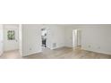 Bright open-concept living space featuring new floors, with doorway into kitchen at 5414 Ansonia Ter, North Port, FL 34287