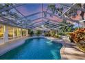 Screened pool with lush landscaping and covered patio for outdoor enjoyment at 5711 Garden Lakes Fern, Bradenton, FL 34203