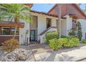Inviting condo with lush landscaping, mature palm trees, and brown and white exterior paint scheme at 6040 Oak Creek Ln # 1822, Bradenton, FL 34210