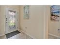 Foyer featuring tile flooring, a decorative glass door and neutral paint at 6642 Willowshire Way, Bradenton, FL 34212