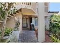 Charming front entrance with a stone path, grill, and unique decor, set amidst mature landscaping at 6780 Schooner Bay Cir # 6780, Sarasota, FL 34231