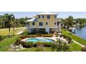Beautiful waterfront home with a private pool, lush landscaping, and a dock at 6802 68Th E Ave, Bradenton, FL 34203