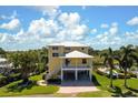 Charming yellow two-story home with covered parking, landscaping, and a pool nearby at 6802 68Th E Ave, Bradenton, FL 34203