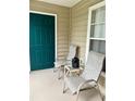 Cozy porch with seating area featuring two chairs, a small table, and a window view at 7411 Vista Way # 102, Bradenton, FL 34202