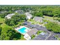 Aerial view of condos, pool, parking and green space at 7858 Eagle Creek Dr # 7442, Sarasota, FL 34243