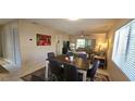 View of living room with a dining table, rug, and nearby open space at 7858 Eagle Creek Dr # 7442, Sarasota, FL 34243