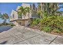 Spacious home featuring a large driveway and lush tropical landscaping at 79 Tidy Island Blvd, Bradenton, FL 34210