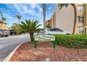Lido Presidential signage surrounded by mature landscaping with a partial building view at 845 Benjamin Franklin Dr # 101, Sarasota, FL 34236