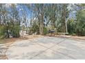 An expansive concrete patio features outdoor seating and a grill, ideal for entertaining by the water at 891 Palmetto Ne Dr, Port Charlotte, FL 33952
