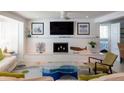 Bright living room featuring a white brick fireplace and large windows with natural light at 91 Avenida Veneccia, Sarasota, FL 34242