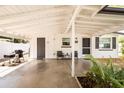 Inviting covered front porch with seating, a grill, and a well-lit entrance at 1018 Charlotte Ave, Sarasota, FL 34237