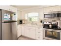 Bright kitchen features stainless steel appliances, white cabinets, and ample counter space at 1018 Charlotte Ave, Sarasota, FL 34237