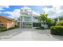 Charming home with a rooftop deck, beautiful landscaping, and ample parking at 113 8Th S St, Bradenton Beach, FL 34217