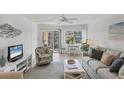 Cozy living room with comfortable seating and scenic views of the enclosed balcony and waterfront at 1250 N Portofino Dr # 304, Sarasota, FL 34242