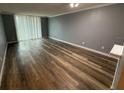 Spacious living room featuring modern gray walls and new hardwood floors at 2700 Coconut Bay Ln # 432, Sarasota, FL 34237