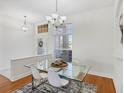An airy dining room features a modern glass table set and matching decor at 2931 Bravura Lake Dr, Sarasota, FL 34240
