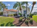 Lush landscaping adds curb appeal to this single Gathering home, with its terracotta roof and attached two car garage at 2931 Bravura Lake Dr, Sarasota, FL 34240