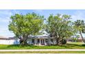 Lovely home with large trees and a well-manicured lawn at 2961 Valencia Rd, Venice, FL 34293