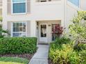 Charming condo entrance featuring a well-lit doorway and vibrant landscaping at 4355 Longmeadow # 23, Sarasota, FL 34235