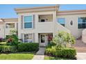 Charming condo with stairs, complemented by lush greenery and manicured landscaping at 4355 Longmeadow # 23, Sarasota, FL 34235