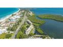 Aerial view showcases a waterfront condo, boat docks, and proximity to the beach at 4500 Gulf Of Mexico Dr # Ph4, Longboat Key, FL 34228