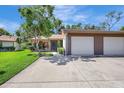 Inviting home with two-car garage, lush landscaping, and a well-maintained driveway at 4722 Oak Hill Ln # 44, Sarasota, FL 34232