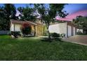 Charming home with well-manicured lawn, blossoming tree, and attached two-car garage at 4722 Oak Hill Ln # 44, Sarasota, FL 34232