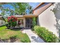 Charming single-story home featuring a well-manicured lawn and screened in porch at 4722 Oak Hill Ln # 44, Sarasota, FL 34232