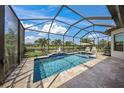 Relaxing screened-in pool area with a sparkling pool, lounge chairs, and a view of the water at 4726 Zeno Ct, Bradenton, FL 34211