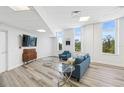 Bright living room featuring a comfortable seating area, stylish furniture, and large windows with scenic views at 516 Tamiami S Trl # 102, Nokomis, FL 34275