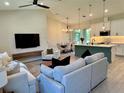 Open-concept living space featuring modern furnishings, sleek lighting fixtures, and seamless flow to the dining area at 5473 Gagnon Ter, North Port, FL 34291