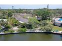 A waterfront property with a dock and lush landscaping, perfect for relaxation at 5502 Shadow Lawn Dr, Sarasota, FL 34242