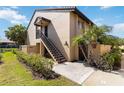 Exterior view of condo with stairs, landscaping, and palm trees at 5624 Ashton Lake Dr # 5624, Sarasota, FL 34231