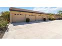 Attached garage with multiple bays and concrete driveway and tile roof at 5624 Ashton Lake Dr # 5624, Sarasota, FL 34231