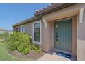 Home featuring a green front door, manicured landscaping, and brick-paved walkway at 6120 Plateau Ct, Bradenton, FL 34203
