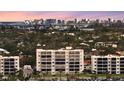 Apartment building exterior showcasing multiple windows and a city skyline in the background at 777 Beach Rd # 1B, Sarasota, FL 34242