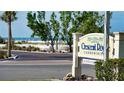 A real estate sign for Crescent Royale Condominiums with the beach visible behind it at 777 Beach Rd # 1B, Sarasota, FL 34242