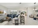 Open-concept living area with tile flooring, comfortable seating, and views to the pool at 8146 Shadow Pine Way, Sarasota, FL 34238