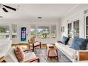 Bright living room featuring hardwood floors, white sofas, blue accents, and a decorative stained glass door at 829 Bayshore Blvd, Tampa, FL 33606