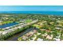 Stunning aerial view of a waterfront home featuring serene waterways and lush landscaping at 9226 13Th Avenue Nw Cir, Bradenton, FL 34209
