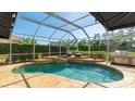 Relaxing screened-in pool area with a built-in spa and an outdoor grilling area at 9226 13Th Avenue Nw Cir, Bradenton, FL 34209