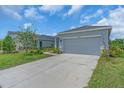 Inviting single-story home with a well-manicured lawn and a spacious driveway at 10616 High Noon Trl, Parrish, FL 34219