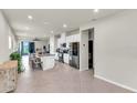 Open-concept kitchen with a central island, stainless appliances, and tile floors at 10616 High Noon Trl, Parrish, FL 34219