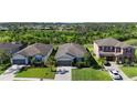 Aerial view of a neighborhood highlighting the home's location near green spaces at 10806 52Nd E Ct, Parrish, FL 34219