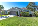 Well-maintained single-story home with lush landscaping, attractive yard and a two-car garage at 10806 52Nd E Ct, Parrish, FL 34219