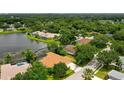 Aerial view of a home and pool surrounded by lush greenery and a tranquil lake at 11215 Rivers Bluff Cir, Lakewood Ranch, FL 34202