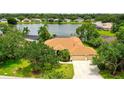 Beautiful lakefront home with a well-manicured lawn and lush landscaping at 11215 Rivers Bluff Cir, Lakewood Ranch, FL 34202